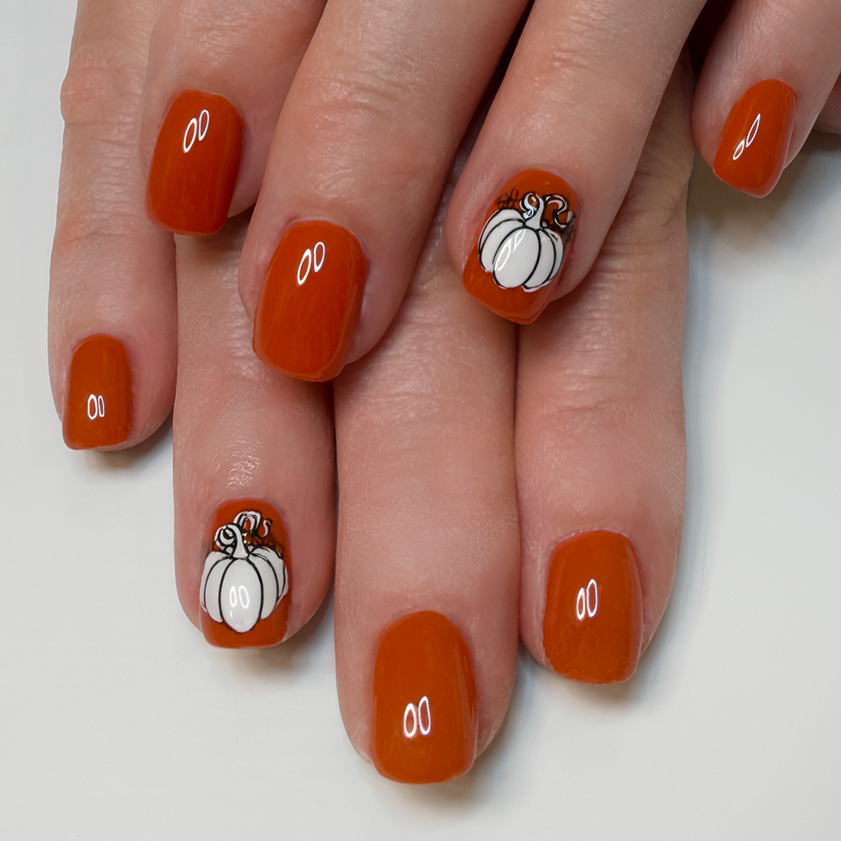 Luminary structured gel manicure with pumpkin nail art at Over the Moon Nail Salon in Manchester, NH.